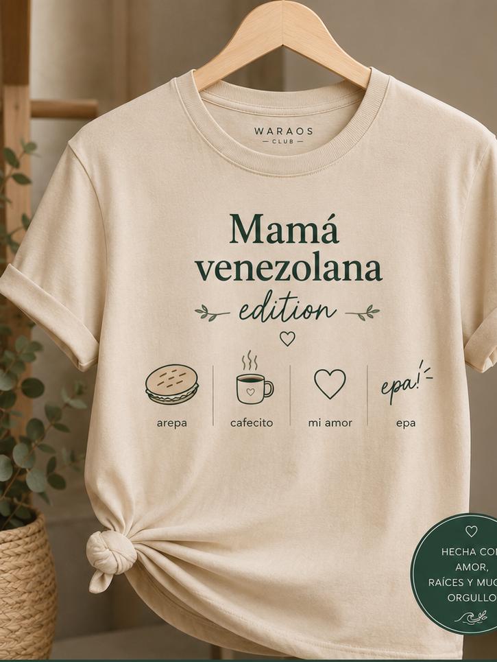 Franela Waraos “Mamá venezolana edition” colgada, con íconos de arepa, cafecito, mi amor y epa